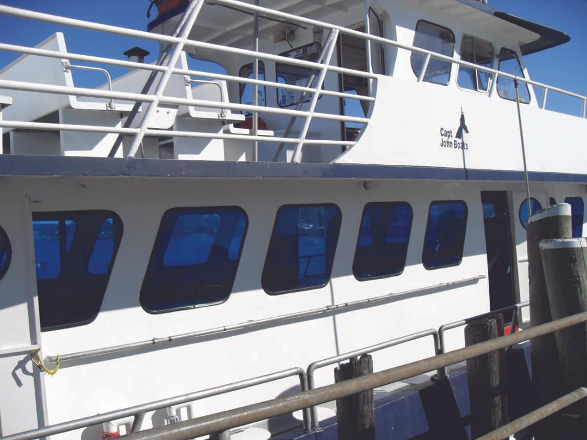 charter-boat-with-blue-tint-on-windows-min White charter boat with blue tinted windows.
